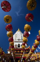 Ban Po  the Pagoda of a Thousand Buddhas seen between strings of red and yellow coloured Chinese New Year lanterns.