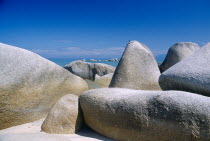 Beach with close view of large  smooth rocks.