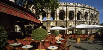 Nimes.  Cafe with outside tables in front of the Arenes.