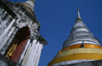 Wat Chedi Luang. Statue of standing Buddha in an alcove  beside a stuppa with a man walking around it Asian Prathet Thai Raja Anachakra Thai Religion Siam Southeast Asia Male Men Guy Religious Siames...