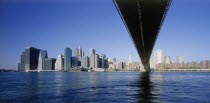 Lower Manhattan.  Post September 11 skyline from Brooklyn with underside of bridge in the foreground.