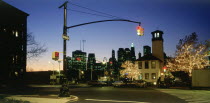 Lower Manhattan.  Post September 11 skyline from Old Fulton Street in Brooklyn at night with pedestrian crossing and traffic lights in the foreground.