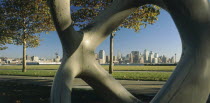 Lower Manhattan.  Post September 11 skyline seen from a public park in Hoboken  New Jersey part framed by modern sculpture in the foreground.