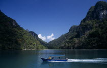 Pulau Dayang Bunting island with a traditional covered boat used for transport between the islandsAsian Malaysian Southeast Asia Classic Classical Historical Holidaymakers Older Scenic Southern Touri...