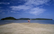 Pantai Cenang beach with people walking on the sand bar at low tide to Pulau Rebak Kecil islandAsian Beaches Inn Malaysian Pub Resort Sandy Seaside Shore Southeast Asia Tavern Tourism Holidaymakers P...