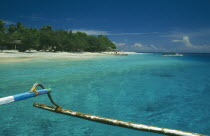 Gili Trawangan beach seen from approaching outrigger canoe in clear water