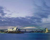 The Opera House and Harbour Bridge lit up at dusk