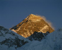Mount Everest peak bathed in golden evening sunlight