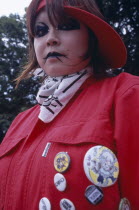 Harajuku District. Portrait of young teenage girl wearing a red jacket and elaborate punk style makeup and piercing