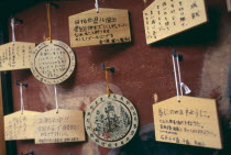 Sanjusangen do Temple. Ema wooden votive tablets hanging from hooks on a wall