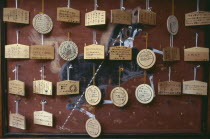 Sanjusangen do Temple. Ema wooden votive tablets hanging from hooks on a wall