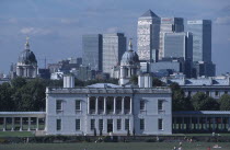 Greenwich. View over lawn toward Queens House with the Canary Wharf skyline beyond