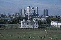 Greenwich. View over lawn toward Queens House with the Canary Wharf skyline beyond