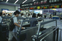 Passengers passing through electronic ticket styles at Kyoto Station