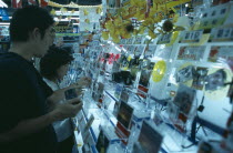 Shinjuku. Customers browsing in Camera shop interior with illuminated displays