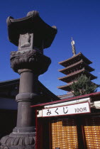Asakusa. Senso Ji Temple. Angled view of the Five Storey Pagoda with ornamental column and other buildings in the foreground