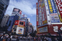Shinjuku. View of advertisement covered architecture in busy city street scene