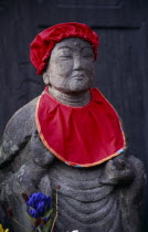 Jizo statue traditionally dressed in red bibs by bereaved mothers and other sufferers