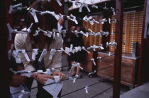Asakusa. People tying Omikuji or Fortune papers at Senso Ji Temple