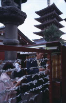 Asakusa. People tying Omikuji or Fortune papers at Senso Ji Temple
