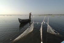 Professional fisherman in canoe on Lake Isac checking his nets