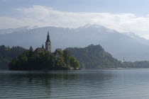 View over the lake toward Bled Island and tower of the Church of the Assumption with Bled town in the background