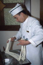 Lanzhou. A cook demonstrating how to make noodles by hand.