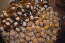 China, Yunnan, Kunming, Covered food market with baskets filled with thousand year old eggs.