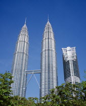 Petronas Twin Towers. Angled view looking up at the multi storey buildings housing corporate headquarters and nearby Maxis building