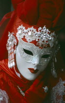 Venice Carnevale. Portrait of a masked figure in a red costume