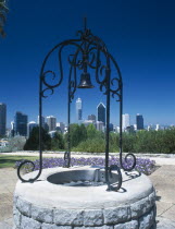 Kings Park well with ornamental ironwork and bell with the city skyline beyond