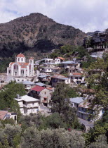 Church and village houses on hillside.