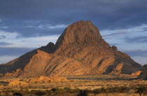 Huge rocky outcrop in barren landscape