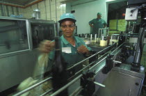 Worker labelling wine bottles at Fairview wine estate