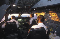 South African Airways Boeing 747 300 cockpit with pilot and crew at daybreak over central Africa on a flight from London to Cape Town