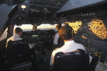 South African Airways Boeing 747 300 cockpit with pilot and crew at daybreak over central Africa on a flight from London to Cape Town