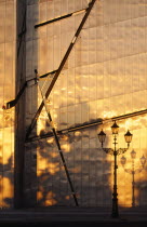Detail of the Judisches Museum metalic exterior reflecting the orange light of the evening sun