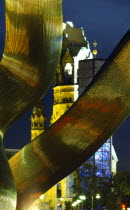 Detail of illuminated wavy metal sculpture entitled Berlin with the Kaiser Wilhelm Gedachtniskirche behind