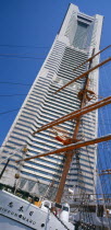 View of the Nippon Maru tall ships mast with Landmark Tower skyscraper behind