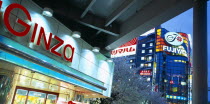 Ginza District. City architecture with large advertising signs illuminated at dusk