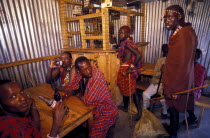 Maasai Moran drinking in a bar. Alcoholism is a particular problem amongst the Maasai.