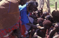 Maasai Moran have the fat from a sacrificial cow daubed on them as well as taking a bite from its flesh during the ceremony that will bring them into manhood.