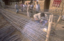 Welder welding the in suite reinforcement of a concrete pile of a high rise building.