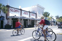 Cyclists on Duval Street outside Sloppy Joes Bar