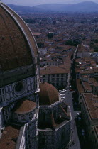 Aerial view of the city streets seen past the domed roof of the Duomo from Giottos Tower