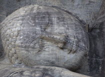 Gal Vihara.  Mid twelth century reclining Buddha figure shown at the moment of entry into nirvana and carved from granite.  Detail of head and face.