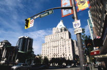 Howe Street sign and traffic signal framing city architecture and Art Gallery on the left