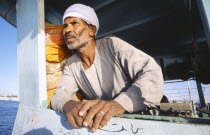 Man leaning on side of ferry.