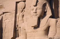 Sun Temple of Ramses II.  Part view of colossi of Ramses II and other statues flanking entrance to temple.