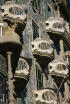 Illa de la Discordia or Block of Discord.  Casa Batllo designed by Guadi 1904 to 1906.  Detail of  mosaic covered exterior wall and curved balconies.